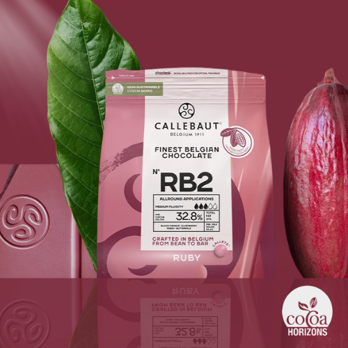Callebaut RB2 Ruby chocolate bag displayed with a cocoa pod, cocoa leaf and ruby chocolate bar.